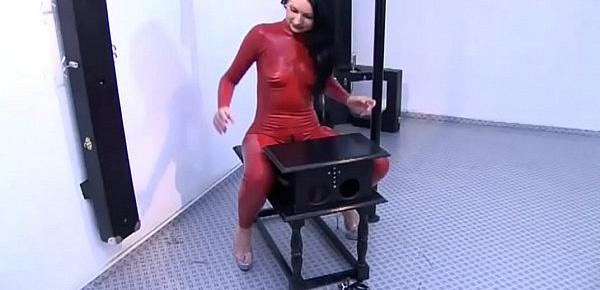  Girl in red latex tied up tries to get out